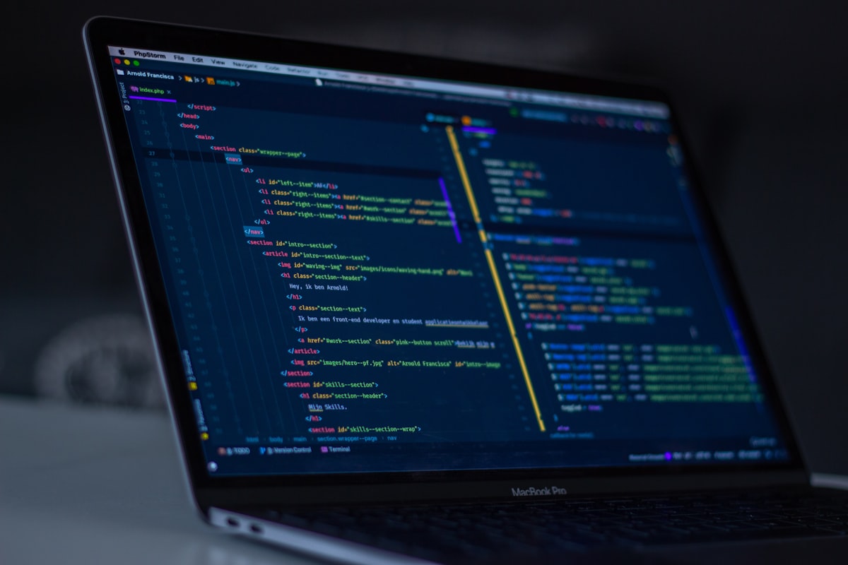 Developer writing code on a laptop screen